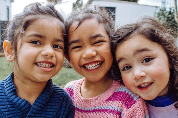 portrait photo of three smiling girls